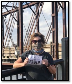 Photo of Annette on a bridge at a running race