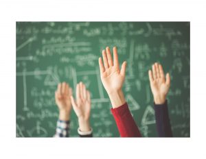 Hands raised in front of chalkboard