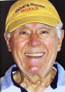 Bob Barry smiling in a yellow hat that says "Yahara House Works"