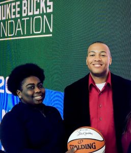 Jerome Flowers and one other person holding a basketball