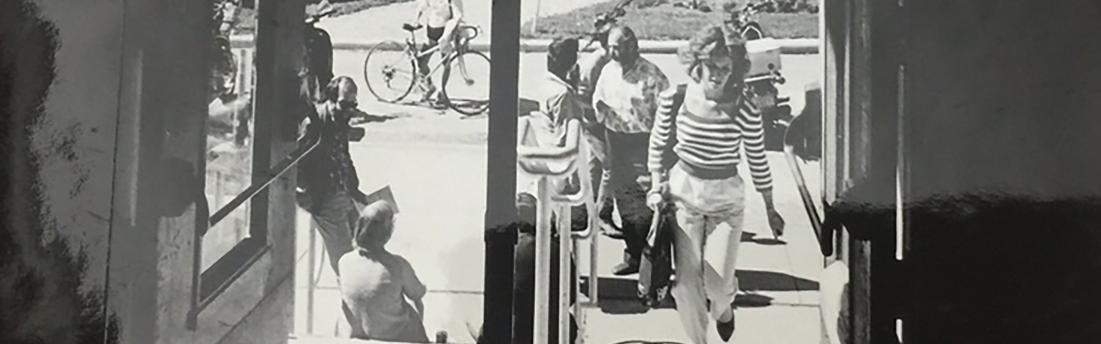 Black and white photo of student walking up steps