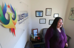 Janie Ocejo standing in office wearing purple shirt