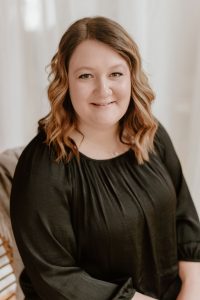 Brianna Sanderfoot smiling in a black blouse